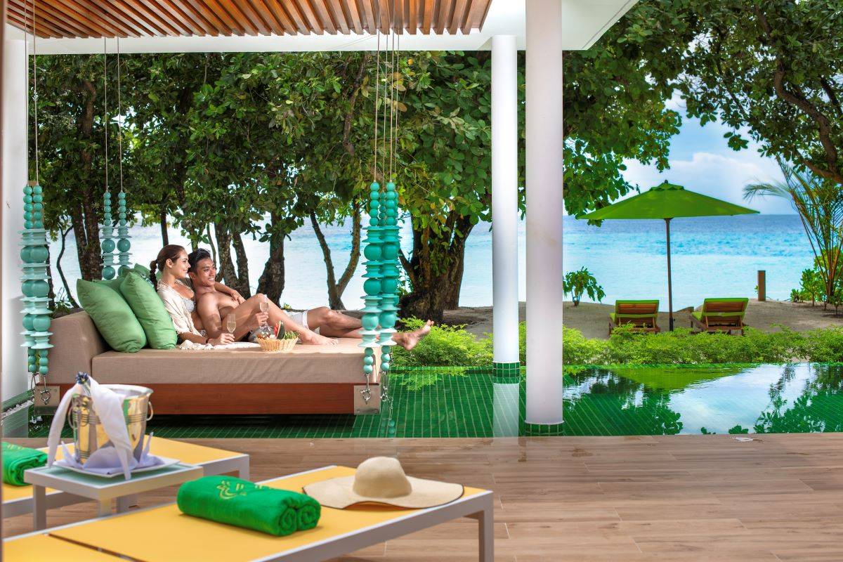 Emerald Maldives Resort & Spa, Malediven, Superior Beach Villa with Pool, Paar auf Daybed